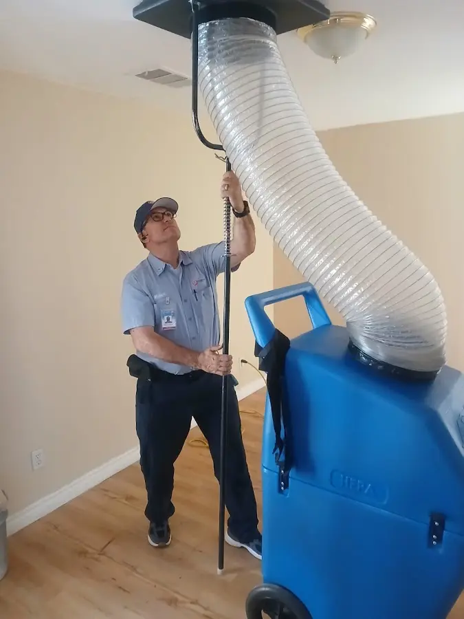 Furnace Tune-Up technician using HEPA equipment in Calera